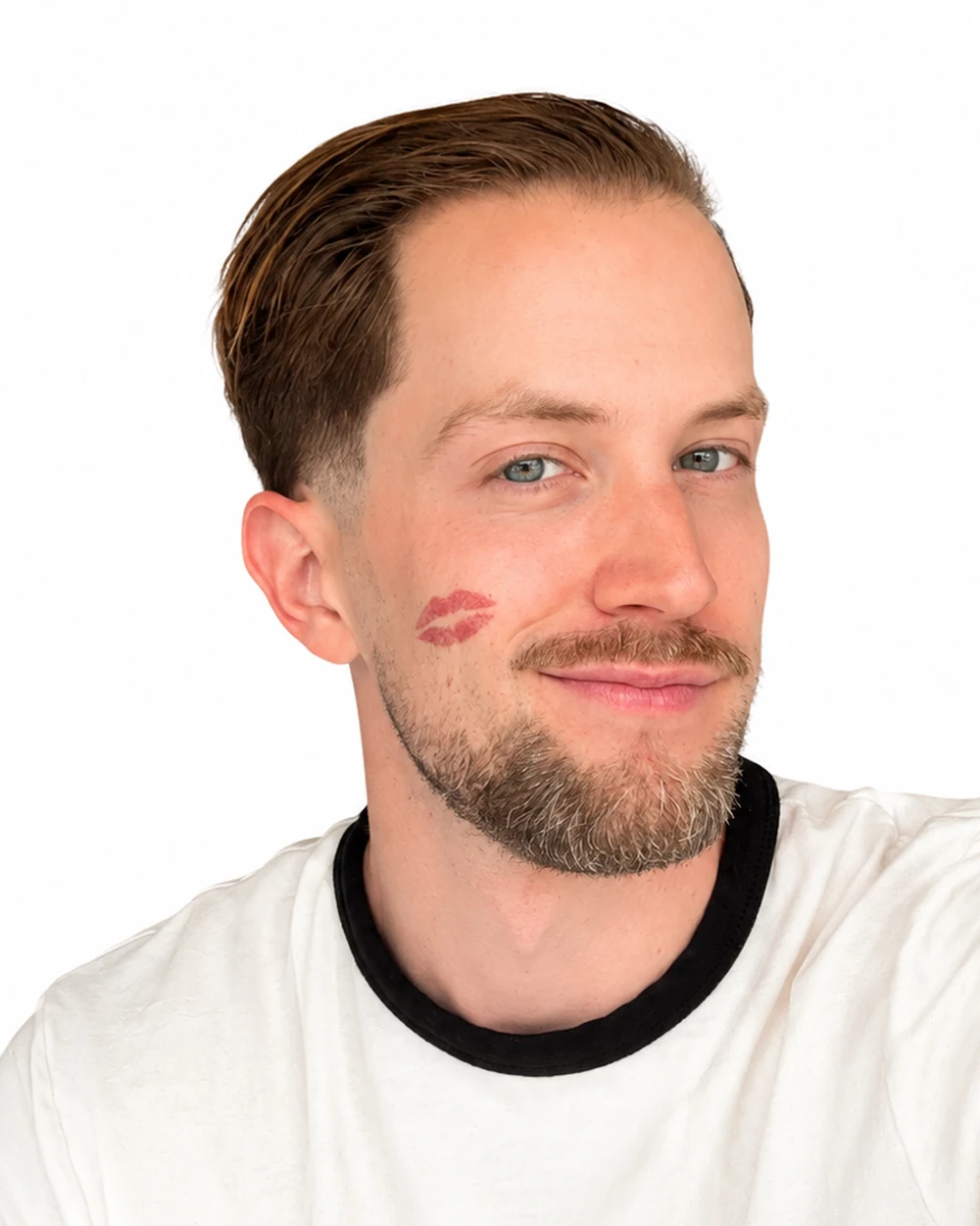Drew Henry, arm outstretched, a lipstick print on his cheek